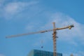 crane is working under the blue sky, for skyscraper construction Royalty Free Stock Photo