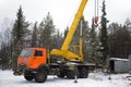 Crane working in the woods in winter Royalty Free Stock Photo