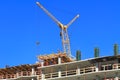 The crane works on the top floors construction multi-storey at home