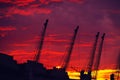 Cranes against dramatic sky at sunset Royalty Free Stock Photo