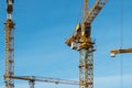 Cranes on blue sky at construction site Royalty Free Stock Photo