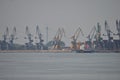 Cranes from Braila port with the bridge over the Danube in the background. Royalty Free Stock Photo