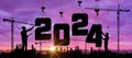 Cranes building construction 2024 year sign. Black silhouette staff works as a team to prepare to welcome the new year 2024. Royalty Free Stock Photo