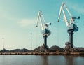 Cranes in the bulk terminal for loading bulk cargo. Two big cranes. Coal. Copy space Royalty Free Stock Photo