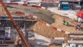 Cranes and bulldozers working at construction site of new skyscraper aerial timelapse. Royalty Free Stock Photo