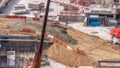 Cranes and bulldozers working at construction site of new skyscraper aerial timelapse. Royalty Free Stock Photo