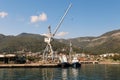 Cranes at cargo terminal in Kotor bay. Montenegro docking station with cranes and tug boats. Royalty Free Stock Photo