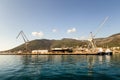 Cranes at cargo terminal in Kotor bay. Montenegro docking station with cranes and tug boats. Royalty Free Stock Photo