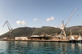 Cranes at cargo terminal in Kotor bay. Montenegro docking station with cranes and tug boats. Royalty Free Stock Photo