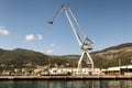 Cranes at cargo terminal in Kotor bay. Montenegro docking station with cranes and tug boats. Royalty Free Stock Photo