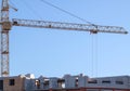 Cranes,construction crane equipment over building construction site on blue sky background on day,technology transportation materi Royalty Free Stock Photo