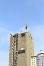 Cranes in construction site with blue sky.