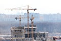 Cranes on construction site build high-rise building Royalty Free Stock Photo