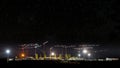 Cranes at construction site, night panorama starry sky Royalty Free Stock Photo