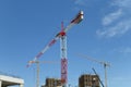 Cranes at costruction site in new urban developing zone Royalty Free Stock Photo