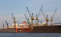 Cranes and a cruise ship in the dock in the port of Hamburg at sunset. Royalty Free Stock Photo