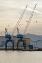 Cranes in the harbor at sunset Royalty Free Stock Photo