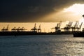 Cranes in a harbor at sunset Royalty Free Stock Photo