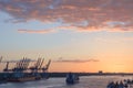 Cranes in a harbor at sunset Royalty Free Stock Photo