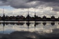 Cranes and houses reflecting in the water at London Royal Docks, London UK Royalty Free Stock Photo