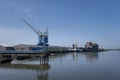 Cranes near the river against blue sky. Industrial landscape, industrial zone Royalty Free Stock Photo