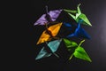 Cranes origami composed of paper of different colors. Cranes are