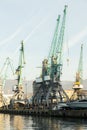 Cranes in the seaport, logistics and delivery of goods on ships, machines for loading containers onto barges Royalty Free Stock Photo