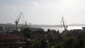 Cranes in shipyard at sunset. Harbour in Adriatic sea. Jackup rig, Oil platform and Container crane in Dockyard. Ship port. Indust