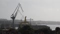Cranes in Shipyard Uljanik in Pula, Croatia. Harbour at Adriatic sea. Cranes, Jackup rig, Oil platform and Container crane in Dock