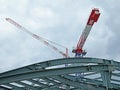 Cranes on the site of a metal frame of a building Royalty Free Stock Photo
