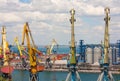 Cranes, tanks and containers in marine cargo port.