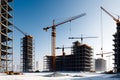 Cranes Towering Over an Unfinished Skyscraper: Steel Beams Forming Skeletal Floors, Concrete Mixers at Work Royalty Free Stock Photo