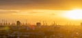 Cranes and wind turbines during sunset in the harbor area of Hamburg, Germany