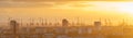 Cranes and wind turbines during sunset in the harbor area of Hamburg, Germany