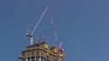 Cranes working on big constraction site works of new skyscraper timelapse