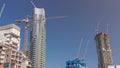 Cranes working on big constraction site works of new skyscrapers timelapse
