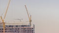 Cranes working on constraction site works of new skyscraper timelapse Royalty Free Stock Photo