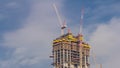 Cranes working on modern constraction site works of new skyscraper timelapse