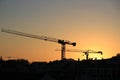 Cranes working at sunset in Lisbon Royalty Free Stock Photo