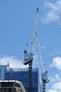 Cranes works in new apartments building block construction site Royalty Free Stock Photo