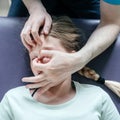 Ostheopatic treatment of a girl patient using CST gentle hands-on technique, central nervous system tension relieve