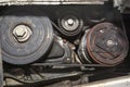 Crankshaft pulley connected by a multi-ribbed belt with tensioner and air conditioning compressor. Royalty Free Stock Photo