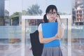 Cranky asian female student in front of university