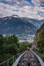 Red Swiss funicular from Sierre to Crans Montana, Valais Canton, Switzerland. Public transport cable car with scenic view over the