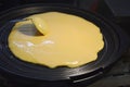 Crape cake cooking on electric teflon pan Royalty Free Stock Photo