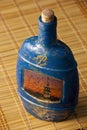 Craquelure decoupage bottle on a mat Royalty Free Stock Photo