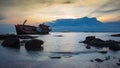 Crash boat on sea during sunset