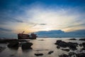 Crash boat on sea during sunset