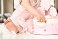 Crash pink cake at the celebration of the first birthday of the girl, ruined sponge cake, broken marshmallow, 1 year Royalty Free Stock Photo