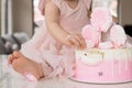 Crash pink cake at the celebration of the first birthday of the girl, ruined sponge cake, broken marshmallow, 1 year Royalty Free Stock Photo